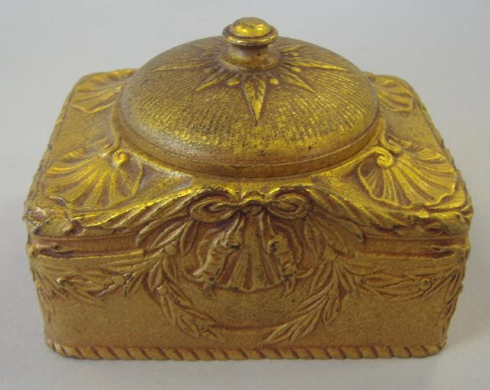 Tiffany Studios Dore Bronze Inkwell: Dore bronze inkwell with shell and swag motif. The underside is signed Tiffany Studios New York, 182. Measures 3.5" wide, 2-3/8" deep and 2" high. NOTE: missing glass insert.