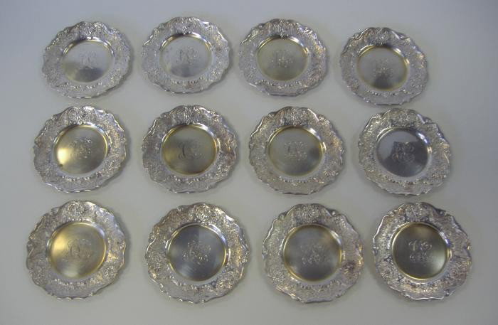 12 Sterling Butter Pats, Whiting Mfg # 2392: Set of twelve sterling butter pats with a gold wash interior and a three initial monogram. Marked on the underside with a pattern number 2392. The pats measure 3" in diameter, with an overall weight o