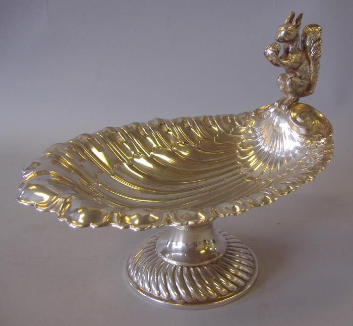 WMF Nickel Silver Nut Bowl with Squirrel Handle: WURTTEMBERGISCHE METALLWARENFABRIK or WMF. Nickel Silver shell formed nut bowl with a handle depicting a squirrel eating a nut. Measures 7.75" to the top of the squirrel, 10" long and 7.5" wide. Perfe