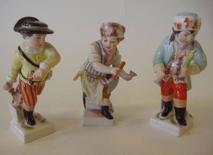 Three KPM Porcelain Young Male Figures: Three porcelain figures by KPM depicting boys in various hunting costumes. Each measuring approximately 4" high. Excellent conditions. See photos for further description.