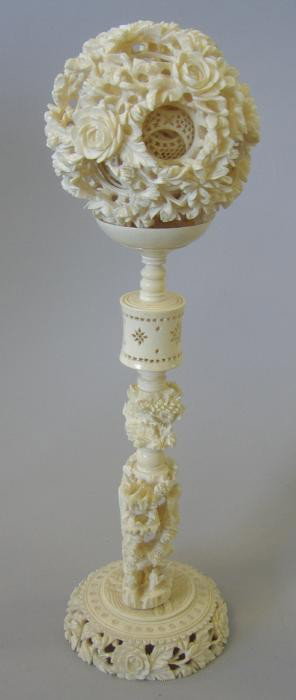 Carved Ivory Puzzle Ball on Stand: Carved ivory puzzle ball with multi-spheres, resting on a carved ivory stand. Overall height 12". The ball measures 3.5" in diameter. Comes with its original presentation box. NOTE: small crack and pa