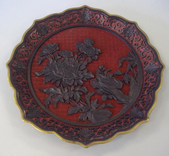 19thc Chinese Carved Cinnabar & Lacquer Tray: 19thc Chinese cinnabar and lacquer serving tray carved in high relief. Brass edging. Measures 11.25" in diameter and 1" high.