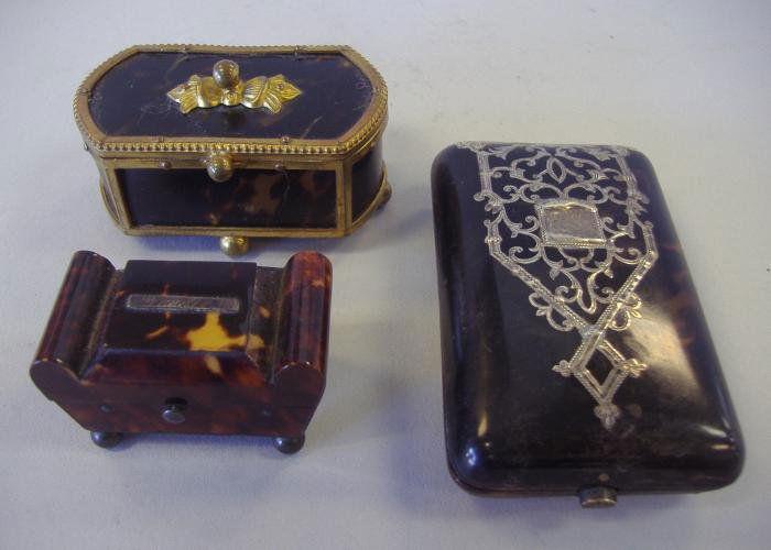 3-19thc Tortoiseshell Boxes, Card, Needles & Snuff: Card case/box with silver overlay, measuring 3" x 2" x .5", together with a snuff box with gilt-brass detailing and a small box with a silver plaque reading needles. All three of tortoiseshell.