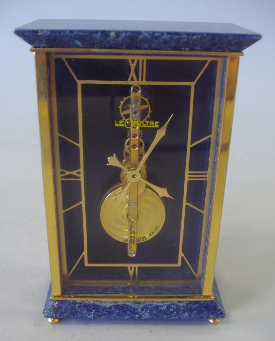 Cartier Le Coultre Lapis Lazuli Atmos Clock: Cartier Le Coultre lapis lazuli and brass Atmos timepiece clock, Swiss, 16 jewels unadjusted. Measures 4.75" high, 3" wide and 1.5" deep. NOTE: No guarantee of working order.