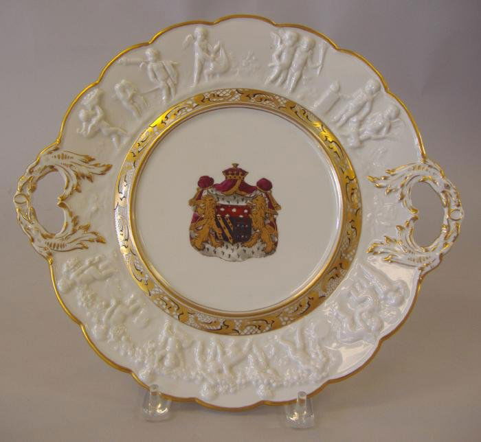Capodimonte Armorial Platter Napoleon: Handled porcelain platter by Capodimonte depicting the armorial crest of Napoleon and Josephine. Raised putti around the border. Signed and identified on the underside. Measures 13.25" from handle to