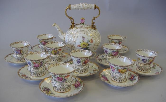 Helena Wolfsohn Dresden Teapot Cups & Saucers: Hand-painted porcelain teapot with ten cups and saucers. All with the mark of Helena Wolfsohn, Dresden (1843-1878). Unique saucers with a raised gallery to hold the cups. The teapot measures 8.75" hig