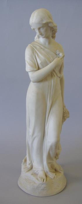 Copeland Parian Figure of a Female with a Lily: Copeland parian figure. The piece depicts a young woman with downcast eyes holding a lily at her breast, (a symbol of a vow of chastity). Overall measurement 17" tall. Impressed Copeland mark, See pho