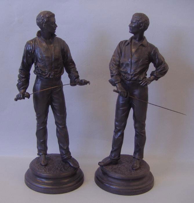 Charles Masse Patinated Metal Models of Fencers: Two spelter patinated metal models of male fencers. Each measuring 24" high and 8.75" in diameter at the base. Signed in the base, Ch. Masse for Rene Charles Masse (1855-1913).