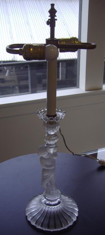 Baccarat Male Figural Candlestick Holder Lamp: Baccarat figural frosted glass candlestick holder / lamp, depicting a draped young male holding a cornucopia. Signed Baccarat on the underside with raised letters. Measures 12.5" high. Comes with a 2-