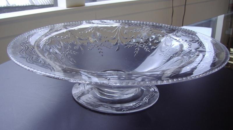 Pairpoint Cut Crystal Centerpiece Bowl: Cut crystal centerpiece bowl with a floral and leaf motif. The bowl measures 14" in diameter and 3.75" high. Unsigned Pairpoint attribution.