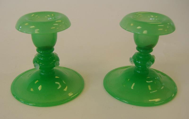 Steuben Jade Green Candlestick Holders with Prunts: Pair of Steuben jade green candlestick holders with four alabaster prunts. Each measuring 3-7/8" high and 3.75" in diameter at the base. Unsigned.