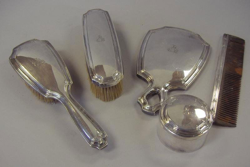 Tiffany & Co Sterling Silver Vanity Set: 5-Piece sterling silver vanity set by Tiffany & Co, comprised of a clothes brush, hair brush, comb, mirror and a small round canister. All 5 pieces with the Tiffany & Co maker's mark.