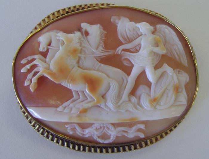 Victorian Cameo Brooch, Winged Male & 4 Horses: Victorian carved shell cameo brooch depicting an winged male with four horses set in 14K gold (tested) surround. Measures 2" high and 2-7/16" wide
