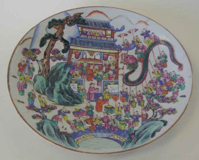 Chinese Porcelain Charger, Enameled Dragon Dance: Chinese porcelain charger with famille rose enamels depicting a scene of young boys dancing in celebration of the dragon. Measures 14.5" in diameter and 2" high