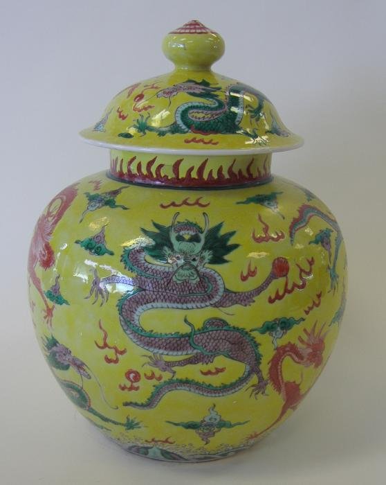 Chinese Porcelain Lidded Jar, 5 Claw Dragon signed: Chinese Qing Dynasty yellow ground porcelain lidded jar. The jar and lid are decorated with enamels depicting a 5-claw dragon. Measures 13" high and 10.5" in diameter. Signed underfoot. NOTE: the rim