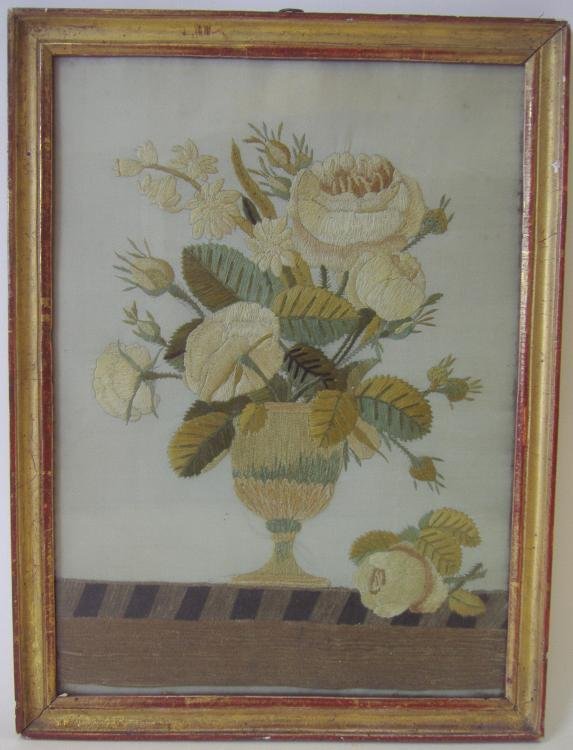 19thc English Needlework Picture, Vase of Flowers: English needlework picture depicting a vase full of abundant flowers sitting on top of a table. Worked in various stitches. Housed in a gilt wood frame. Image measurement 13" x 9.5". The framed measur