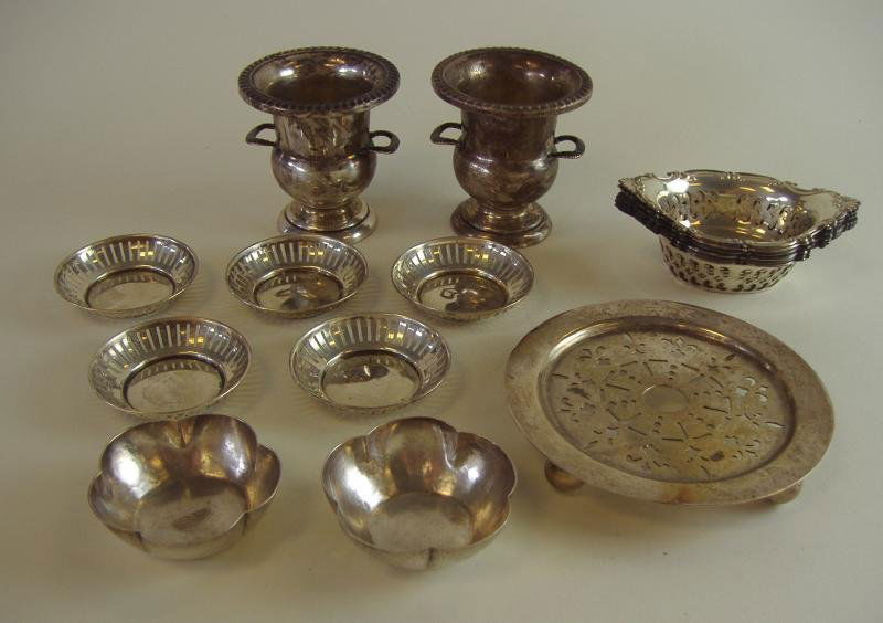 Sterling Nut Dishes, Toothpick Holders, Trivet: Sterling silver comprised of 13 nut dishes by Birks, Gorham, Kalo and an unidentified mark showing a man's face in profile, together with two toothpick holders by Hunt and a small round trivet measuri