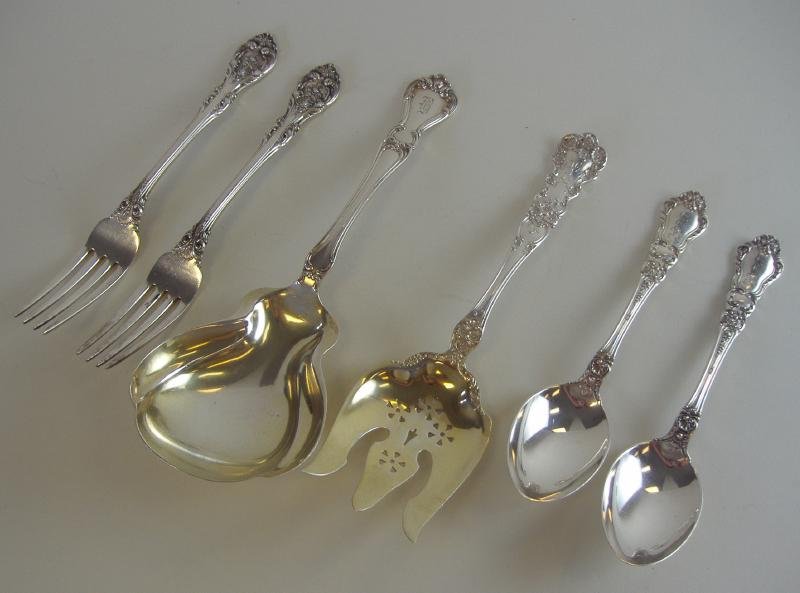 Gorham Sterling Flatware + Serving Pieces: Gorham sterling flatware comprised of 2 dinner forks in the King Edward pattern, 2 table spoons in the Baronial Old pattern (monogrammed) a serving spoon in the Buckingham pattern and a serving fork i