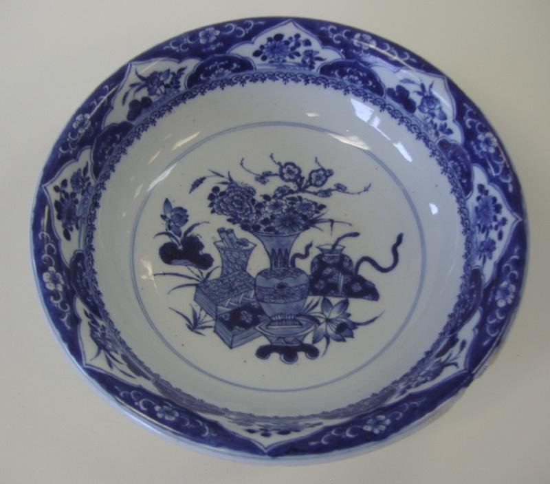 Chinese Kangxi Porcelain Footed Bowl: Chinese Kangxi (1662-1722) , blue and white porcelain footed bowl with a curved rim. The bowl measures 11" in diameter and 3.5" high. NOTE: Some chipping at rim.