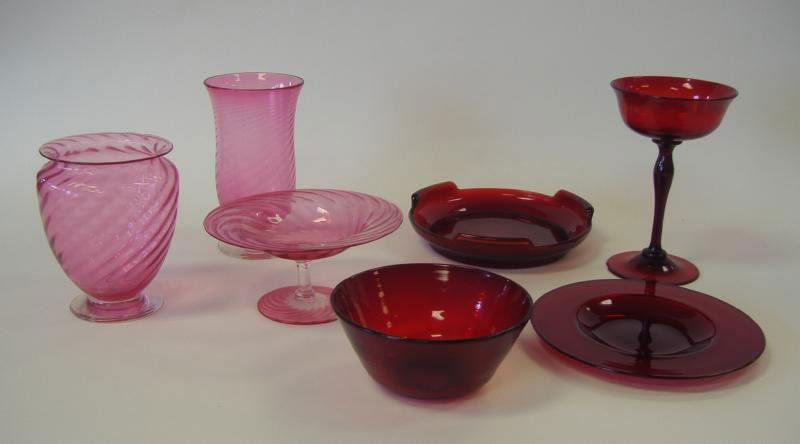 Cranberry & Ruby Art Glass Collection: Cranberry swirl art glass compote and 2 vases, together with a ruby glass bowl, plate, tray and goblet. The tallest piece, the goblet measures 6.5" high. Total of 7 pieces. NOTE: small chip to foot of