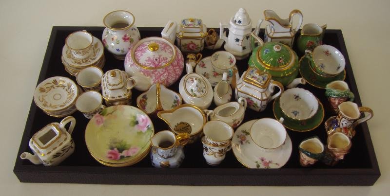 Porcelain Miniature Tea Sets, Toby jugs, Spode etc: Large grouping of porcelain miniature tea sets and pitchers. Various makers to include, Spode, Royal Crown Derby, Crown Staffordshire, Limoges, Royal Doulton, Portugal and French porcelain.