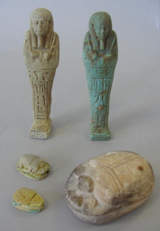 2 Egyptian Ushabti Shabti & 3 Heart Scarabs: Two terra cotta Egyptian Ushabti or Shabti figures, each measuring 4-1/8" high. Together with three heart scarabs. The largest scarab measures 2.5" long, 1-5/8" wide and 1" high. The two smaller scara
