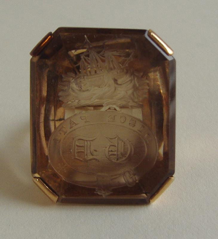 14K Gold Intaglio Signet Seal Ring Learn to Endure: 14K gold intaglio signet seal ring. Carved with a ship at sea, above the Latin motto Disce Pati. English translation "Learn to Endure". Initials appear to be GD. The stone measures 1" x .75". Ring siz