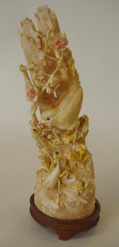 Chinese Carved Ivory Tusk Polychrome Sculpture: Exceptionally well carved Chinese polychrome ivory tusk. The carving depicts a bird perched on a branch among rockery and florals. A flying insect and a praying mantis also inhabit the carving. Fitted