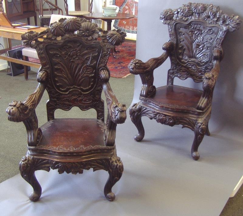 Pair of 19thc Japanese Carved Wood Arm Chairs: Pair of Japanese carved wood arm chairs. 19th century. Well carved on all sides with Asian motifs including iris and chrysanthemum. Measures 44.5" high, 26.5" wide and 20" deep.