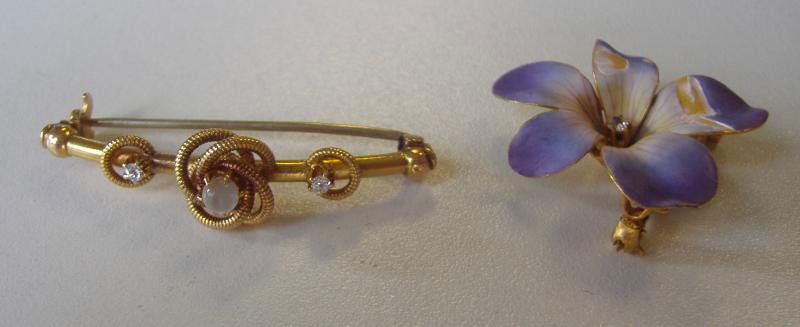 Two Brooch Pins, Diamonds and 14K Yellow Gold: Two Brooch pins. Comprised of an unstamped yellow gold bar-style brooch measuring 1.5" long, set with three stones; one round cabochon moonstone measuring 3.4mm and two European-cut diamonds, of appro