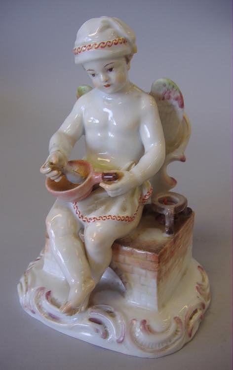 Rare Meissen Nude Male Angel Figure at Hearth: Meissen porcelain figure of a young nude boy angel, c.1763-1774. The cupid sits on a hearth with a spoon in his hand and is mixing a potion in a pan. A small burner with red flame sits next to him. Me
