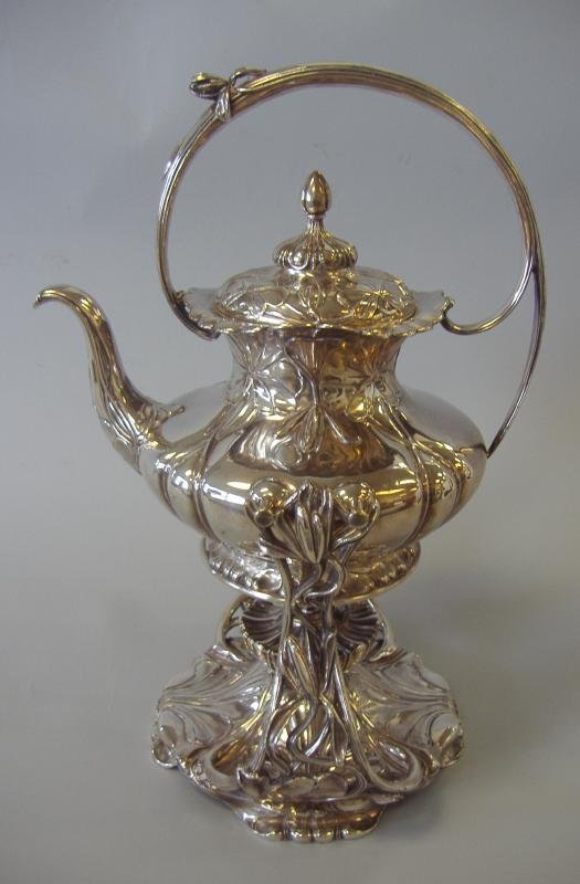 Pairpoint Art Nouveau Silverplate Tilting Kettle: Silverplate tilting teapot or hot water kettle on stand in an Art Nouveau design by Pairpoint. Measures 14" high. Signed on the underside of the kettle and the stand.