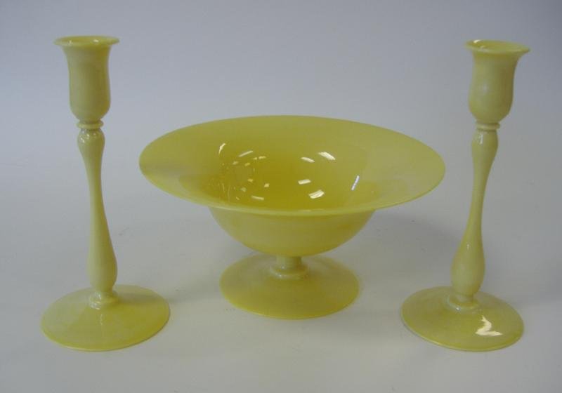 Art Glass Centerpiece Bowl & 2 Candlesticks: Footed centerpiece bowl measuring 10" in diameter and 4.75" high, together with a pair of candlesticks measuring approximately 9" high. Unsigned.