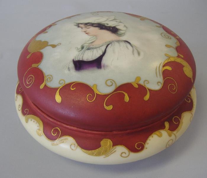 Limoges Porcelain Portrait Dresser Box, Signed: Limoges, France porcelain covered dresser box. Handpainted porcelain portrait of a young woman. Artist signed, M.B. Howe. Measures 6.5" in diameter and 3.25" high.