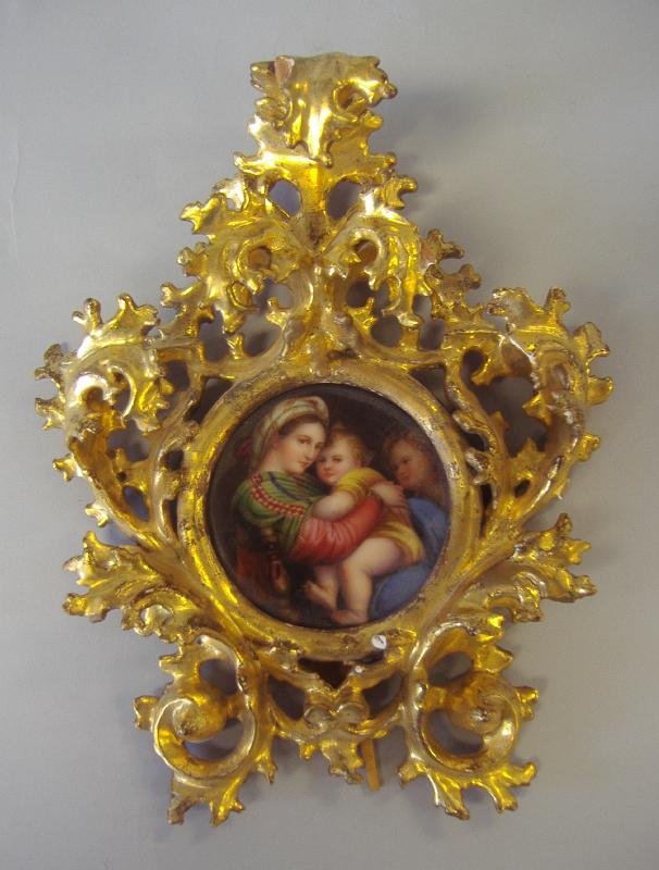 Madonna Della Seggiola Porcelain Plaque, Raphael: Handpainted porcelain plaque "Madonna Della Seggiola" (The Seated Madonna, after Raphael). The plaque measures 3.25" in diameter and is marked Firenze on the backside. Housed in a gilt wood easel fram