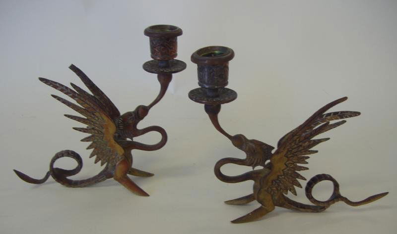Pair of Bronzed Metal Winged Griffin Candlesticks: Pair of bronzed metal candlesticks or candleholders. Formed as winged griffins. c.1930s. Measuring 6.5" high. NOTE: Minor loss to tip of one wing.