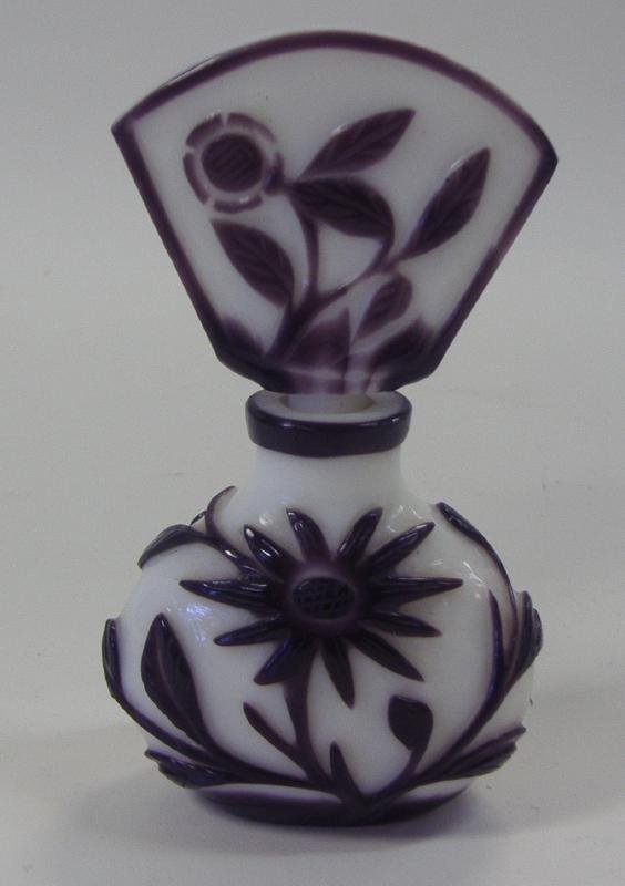 Chinese Peking Glass Perfume Bottle: Carved deep purple florals over a white ground. Measures 4-5/8" high. Provenance: Estate of Robert McKay Shields.