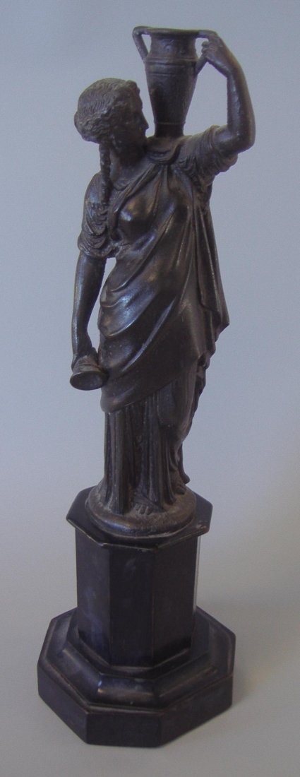 Bronzed Metal Model of a Grecian Goddess: Bronzed metal figure of a Grecian woman or Greco- Roman Goddess holding a vessel on her shoulder and a cup at her side. Overall measurement on wood base 16" tall. Provenance: Estate of Robert McKay Sh