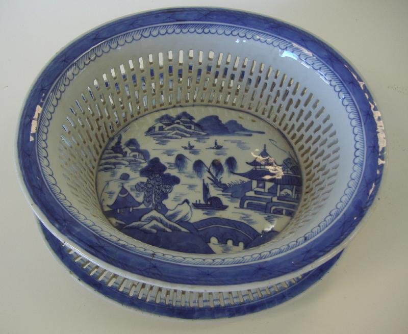19th Chinese Canton Porcelain Fruit Basket & Stand: Chinese blue and white porcelain fruit basket and stand or under tray. 19th century. Canton pattern. The basket measures 10.75" long x 9-5/8" wide x 4"high. The stand measures 11" x 9.75" x 1.5" high.