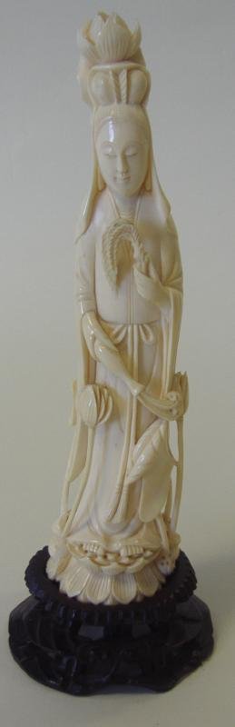Chinese Carved Ivory Female Figure: Well carved antique ivory figure of a standing female holding a feather in one hand and a vase in the other. Overall measurement on carved wood stand 9.25" high. NOTE: Ivory only shipped to a US addre