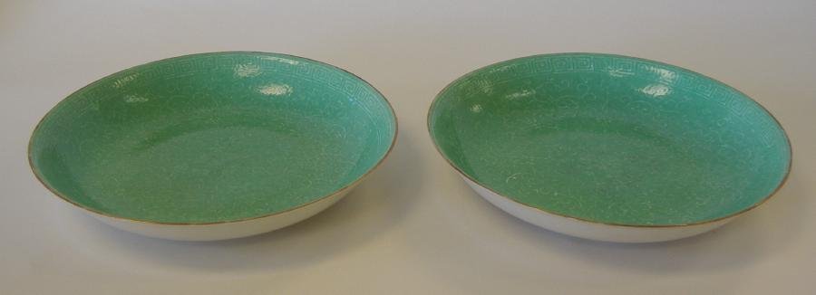 Chinese Apple Green Porcelain Dishes Qianlong Mark: Pair of Chinese apple green dishes with raised relief white decoration. Each bearing a Qianlong mark in over-glaze iron red. Measures 9-3/8" in diameter and 1.75" high. Ex collection of General Joseph