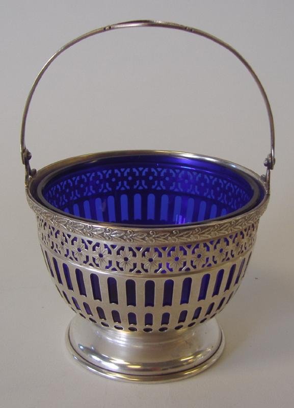 Sterling Silver & Cobalt Sugar Basket by WATSON: Handled basket cage inset with a blue cobalt glass bowl. By the Watson Company. Measures 3.5" in diameter and 5" high to top of handle.