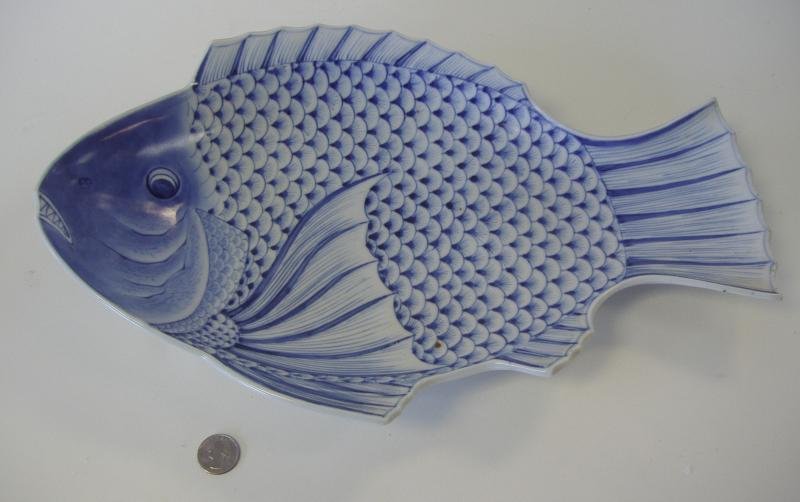 Japanese Imari Fish Shaped Platter Dish, Meiji: Large Imari blue and white porcelain fish formed platter or serving dish. Late 19th/early 20th century. Under-glaze decoration. Measures 17.25" long, 11" wide and 3" high. Signed underfoot. NOTE: very