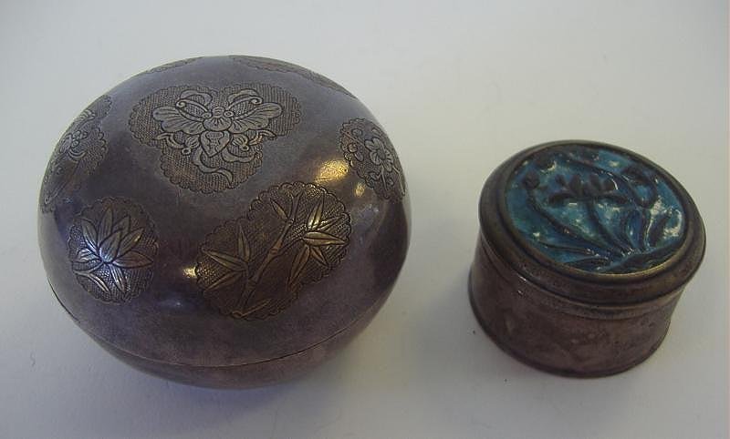 Chinese Silver & Enamel Boxes, Signed: Chinese silver box with a gilt-incised motif depicting a bat, butterfly and florals. Measures 2" in diameter and 1.25" high. Signed underfoot. Together with a silver and enamel box depicting a flower.