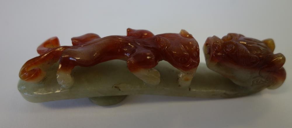 Chinese Carved Jade Double Dragon Belt Buckle Hook: Chinese two-color jade belt buckle hook. Well carved dragon with dragon pup. Measures 4.25" long, 1" wide and 1" high.