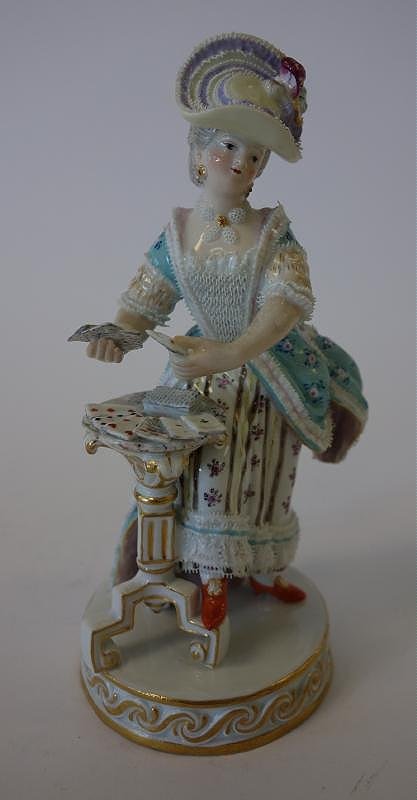 19thc Meissen Porcelain Figure, The Card Player: Meissen porcelain figure. 19th century. Depicts a female figure dealing or playing cards. Measures 6.5" high. Signed underfoot with the Meissen crossed swords mark and faintly impressed numbers.