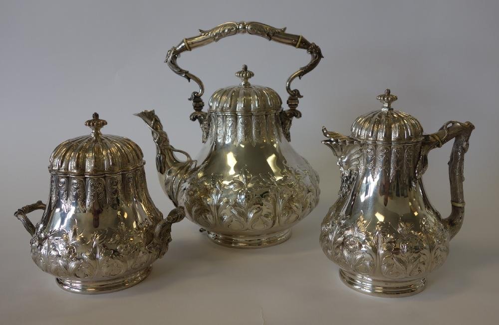 Tiffany Grosjean & Woodward Sterling Tea Service: Sterling silver 3-piece tea service. Created by Grosjean & Woodward for Tiffany & Co. Each piece with hand chased decoration. Comprised of a large tea kettle or coffee pot with embossed and etched flo