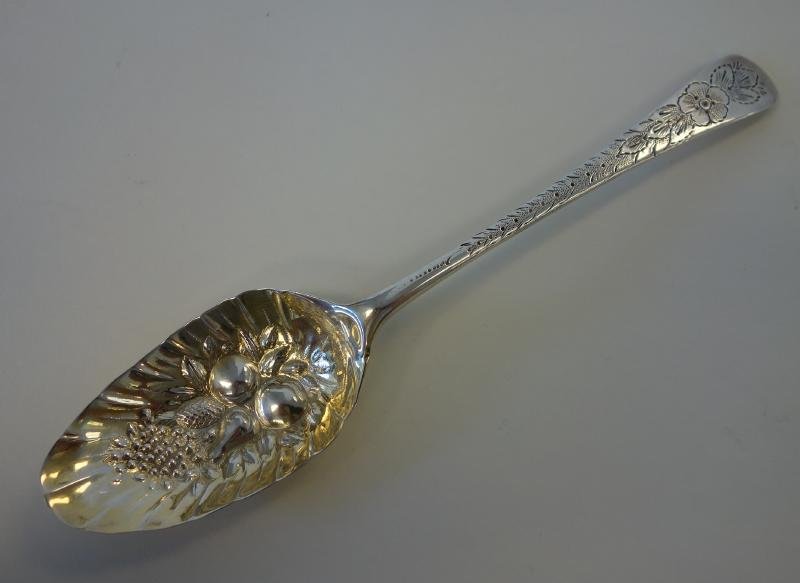 Georgian Sterling Berry Spoon, London 1770: A single sterling silver berry spoon. Hallmarked for London, 1770, Wildman Smith. Embossed fruit decorated bowl. Etched floral and leaf motif on stem and handle. Measures 8.5" long. Weighs 1.79 troy o