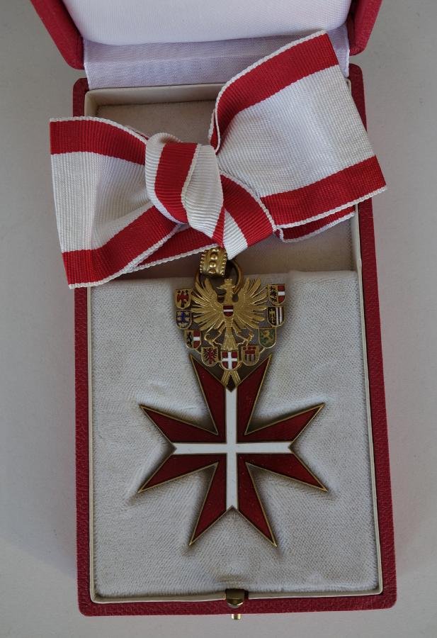 Austrian Enamel White Cross & Eagle Medal: Eagle and star medal. Vienna, Austria. A gilt metal eagle surrounded by nine enameled coat of arms and supporting a red enameled star with white enameled cross. Suspended by a red and white ribbon. Me