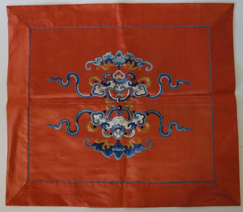 Chinese Silk Embroidered Mandarian Square, Bats: A Chinese silk mandarin square. Fine embroidery with bats and stylized locks with ribbons and swags. measures 17.25" x 19.5".